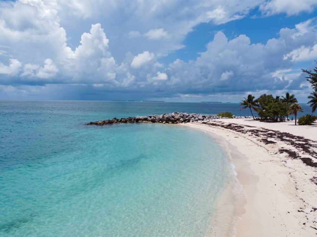 Fort Zachary Taylor beach in Key West Florida with calm clear water and shady palm trees