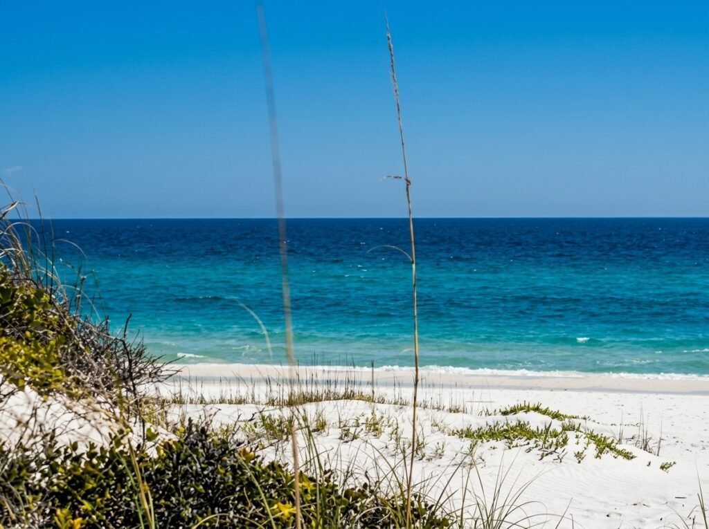 White sandy beach with turquoise water at sunset